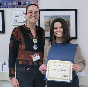 Caila Drew-Morin presenting a certificate to Sidney